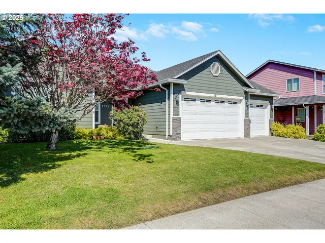 a front view of a house with a yard and garage