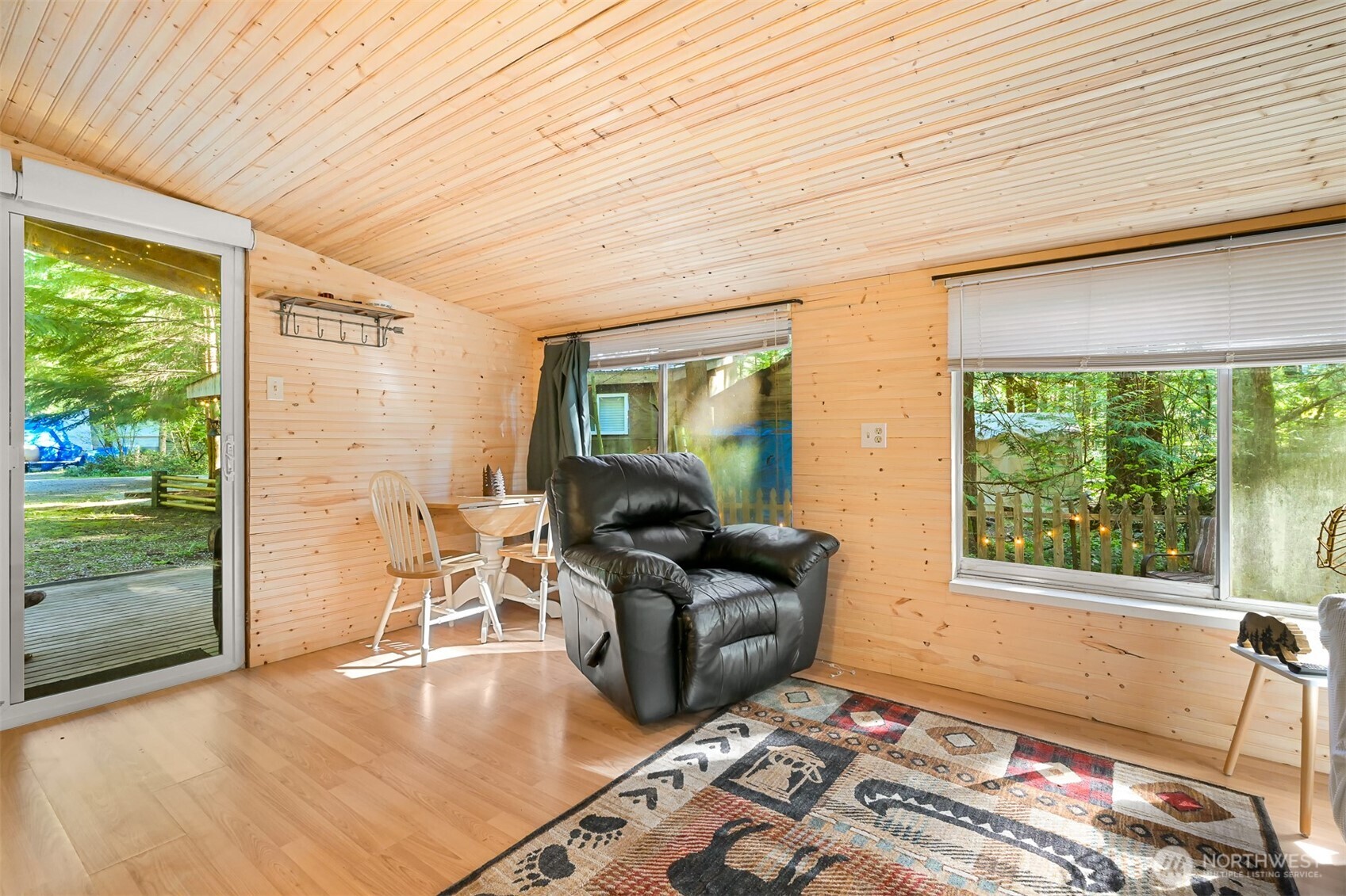 1189 Exit Road Maple Falls, WA 98266 - Photo 12 of 40 a living room with furniture floor to ceiling window and wooden floor