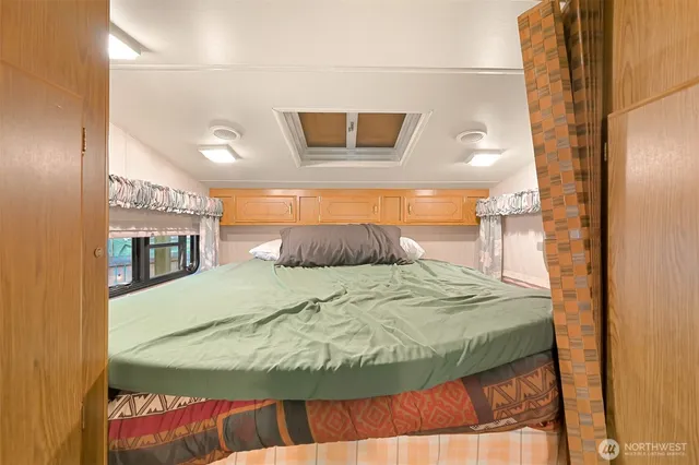 a bedroom with a bed and a mirror