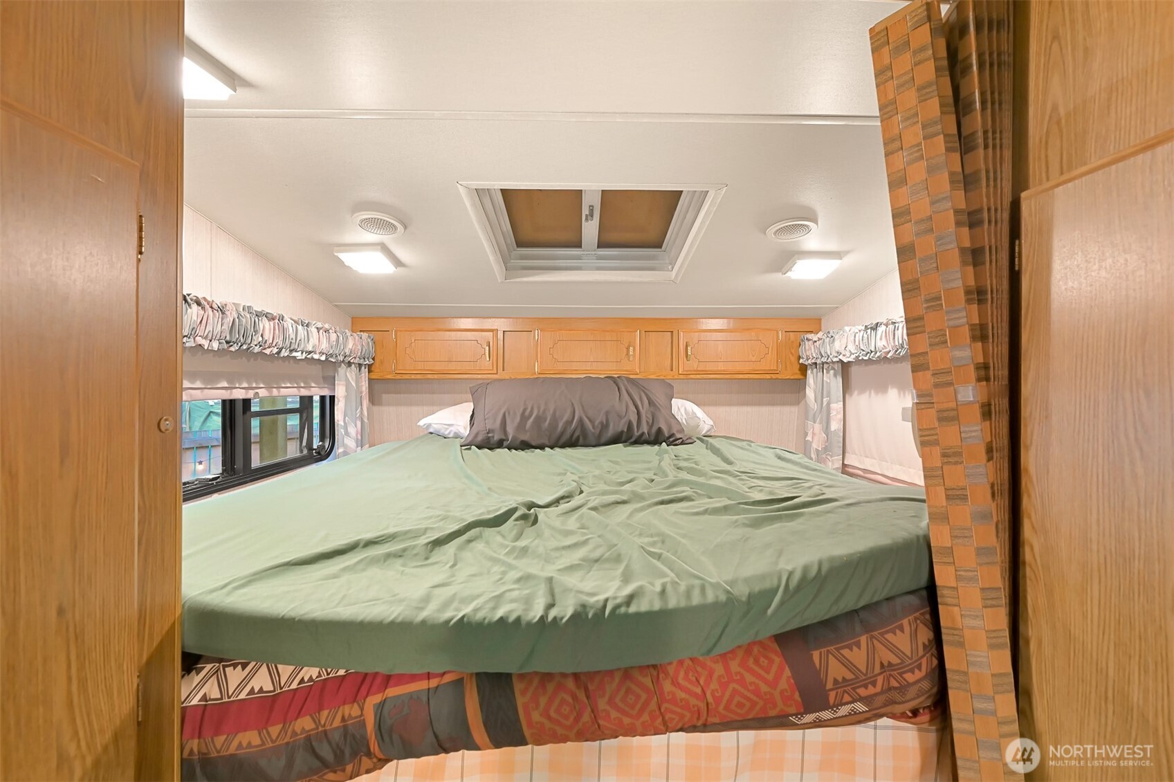 1189 Exit Road Maple Falls, WA 98266 - Photo 22 of 40 a bedroom with a bed and a mirror