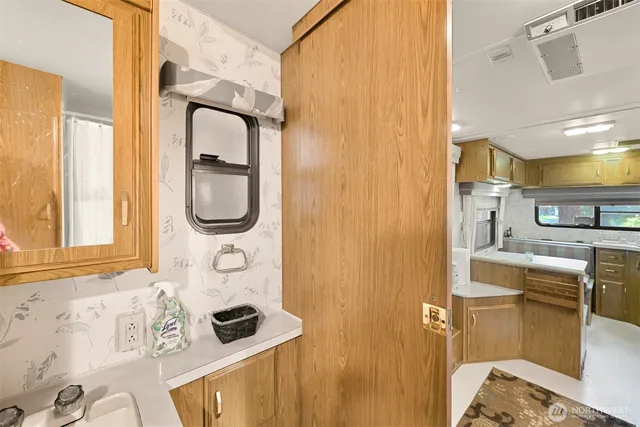 a bathroom with a granite countertop sink and a mirror