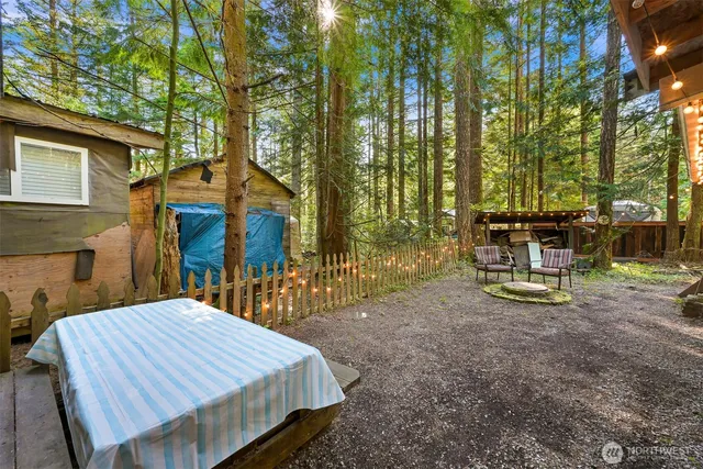 a view of a house with backyard and sitting area