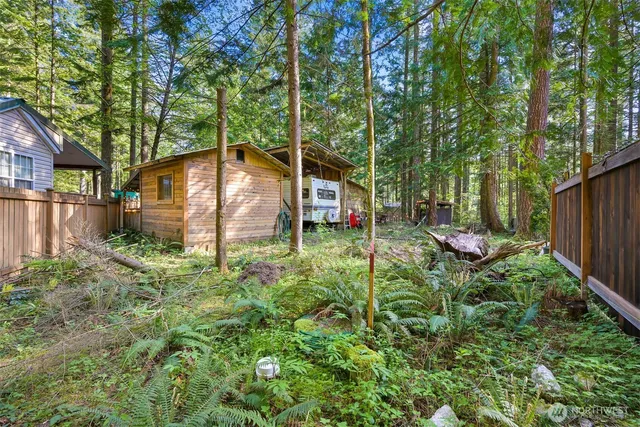 a backyard of a house with plants and outdoor seating
