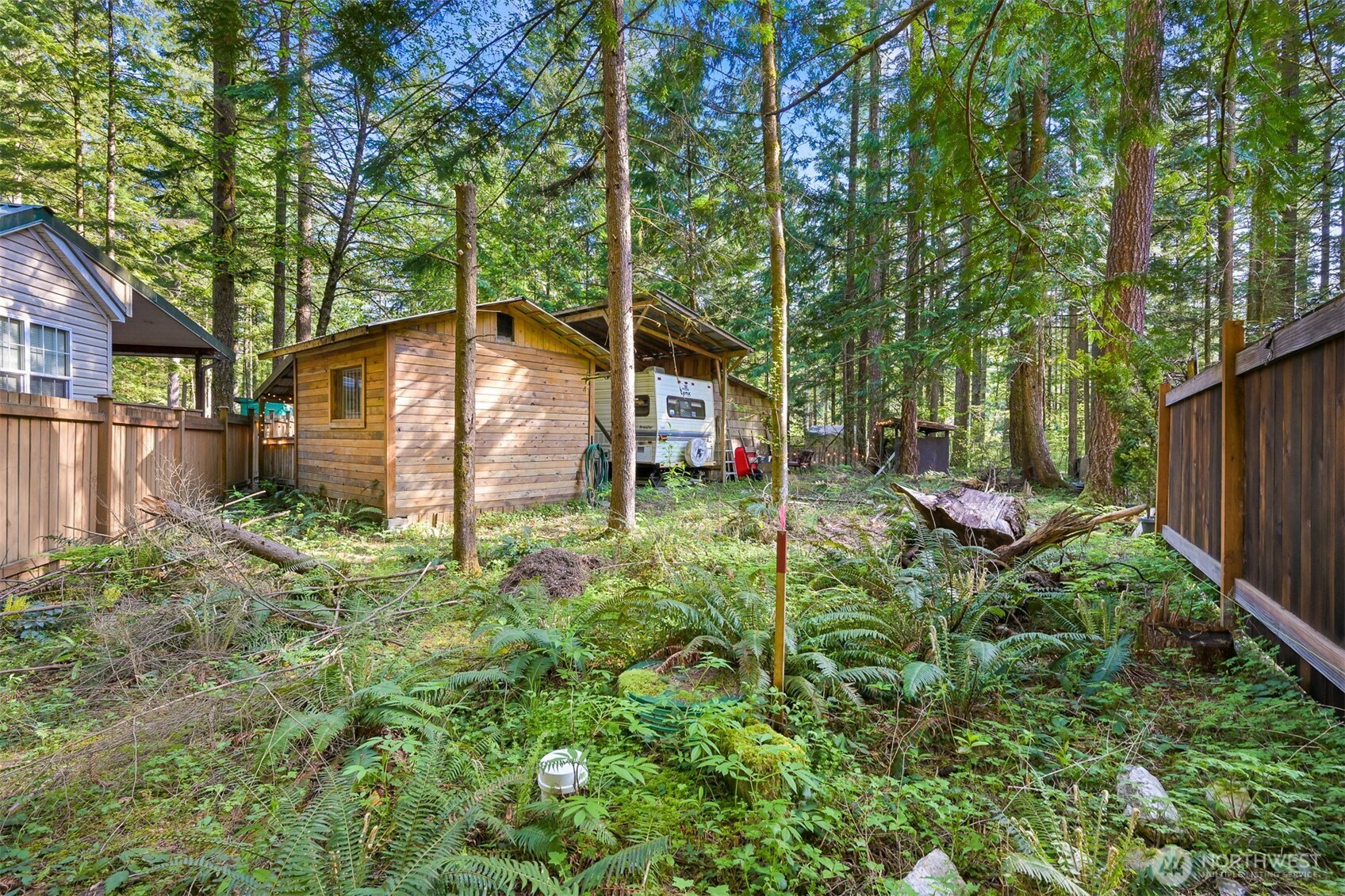 1189 Exit Road Maple Falls, WA 98266 - Photo 26 of 40 a backyard of a house with plants and outdoor seating