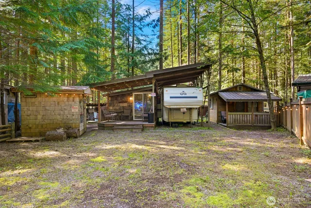 a view of a house with a yard and sitting area