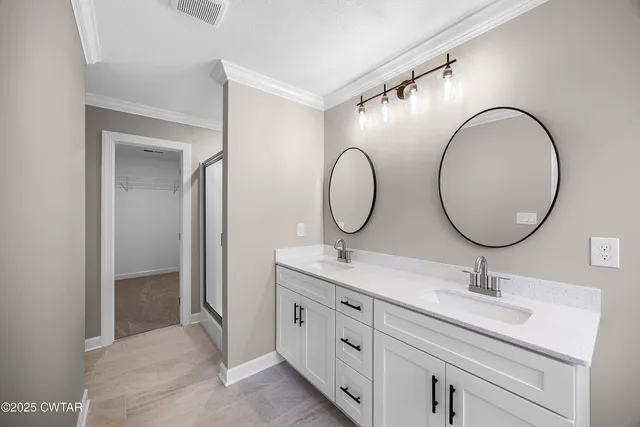 a bathroom with a double vanity sink double and mirror