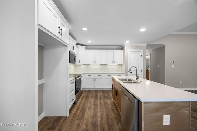 a kitchen with a sink stove and refrigerator