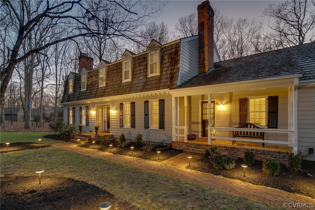 a front view of a building with lots of green space