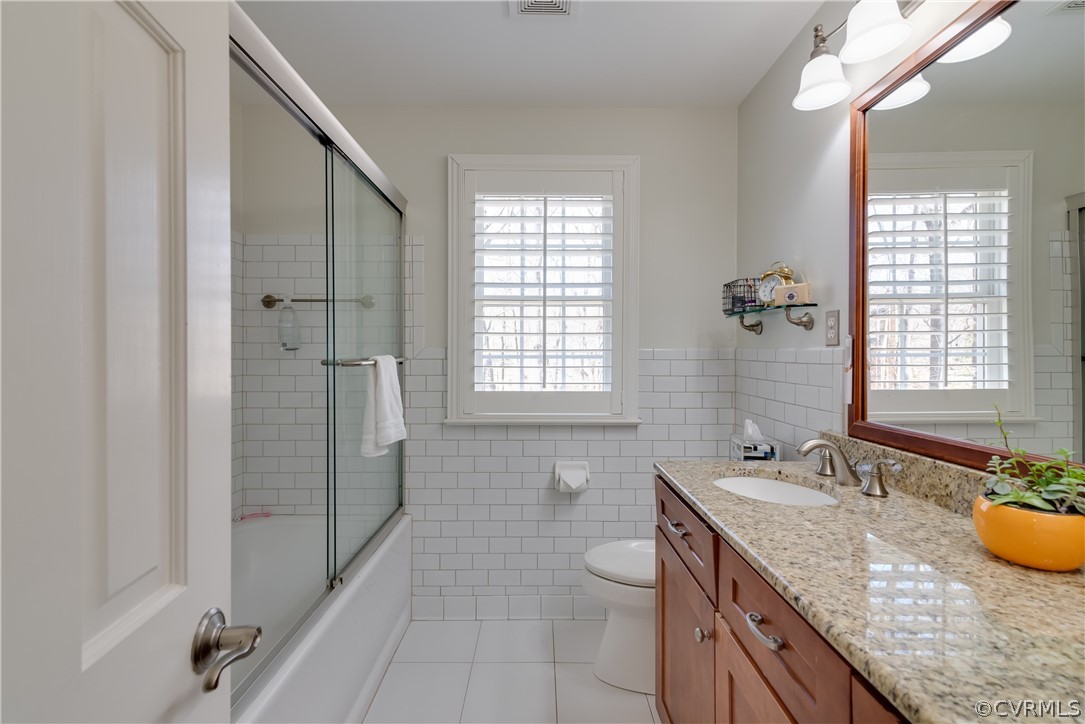 14020 Netherfield Drive Midlothian, VA 23113 - Photo 39 of 50 a bathroom with a granite countertop sink a mirror a bathtub and next to a window