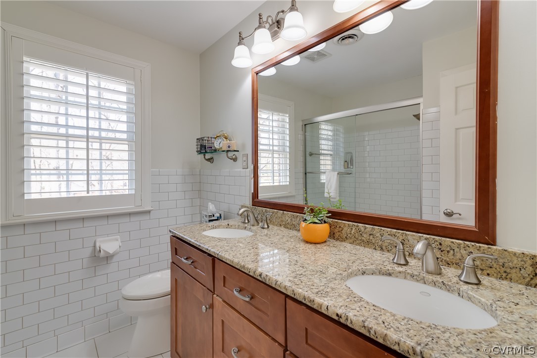 14020 Netherfield Drive Midlothian, VA 23113 - Photo 40 of 50 a bathroom with a granite countertop double vanity sink a mirror and a toilet