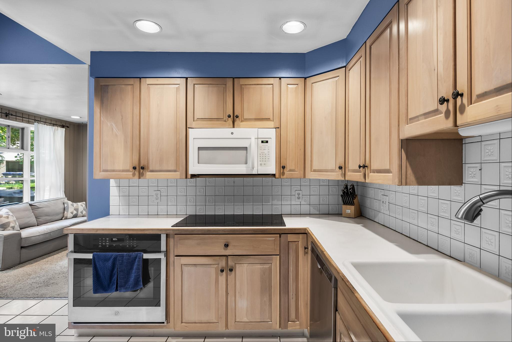 12 Greenvale Road Moorestown, NJ 08057 - Photo 14 of 49 a kitchen with kitchen island granite countertop a sink stove and cabinets