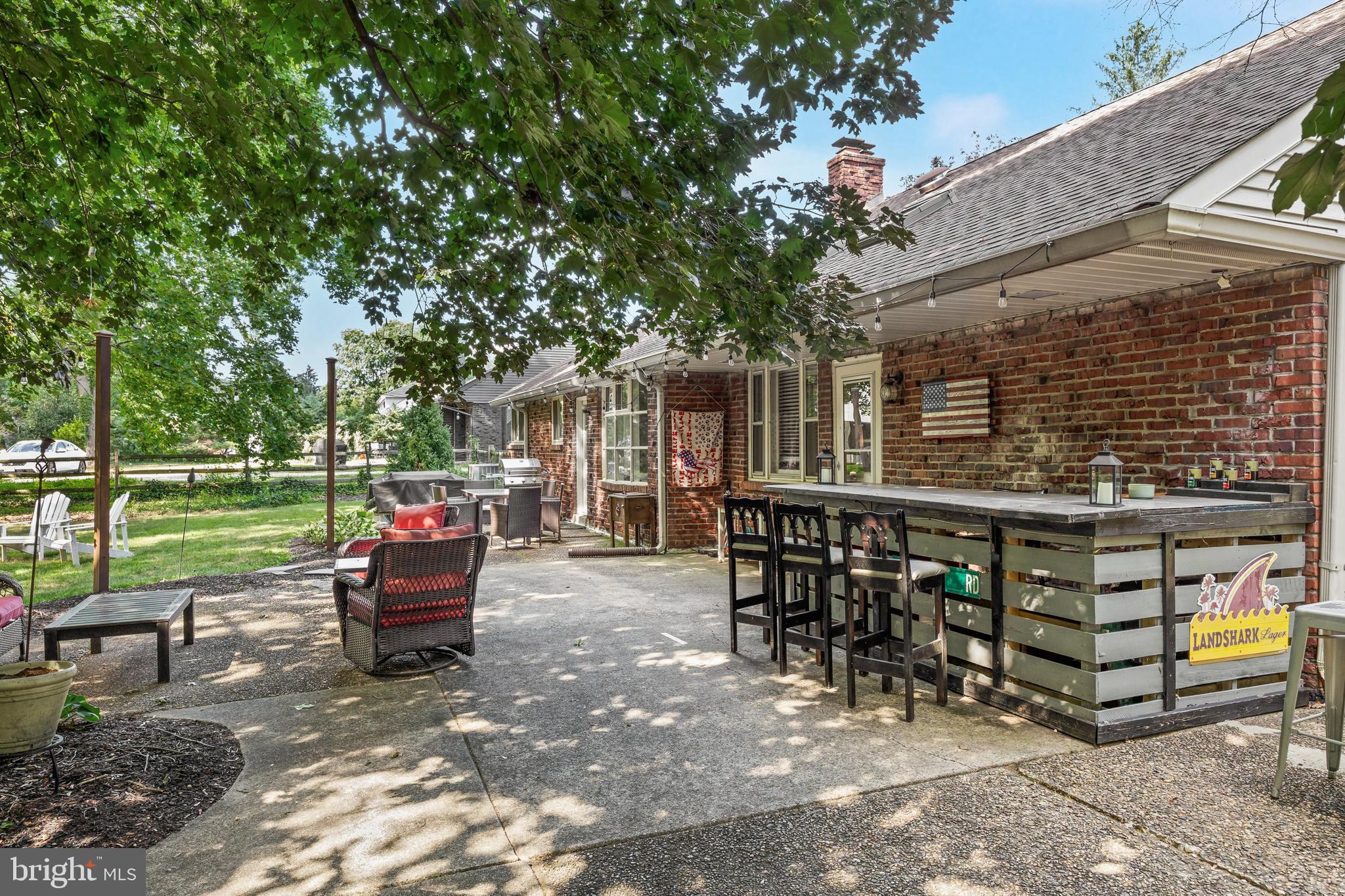 12 Greenvale Road Moorestown, NJ 08057 - Photo 31 of 49 a view of a chairs and tables in the back yard of the house