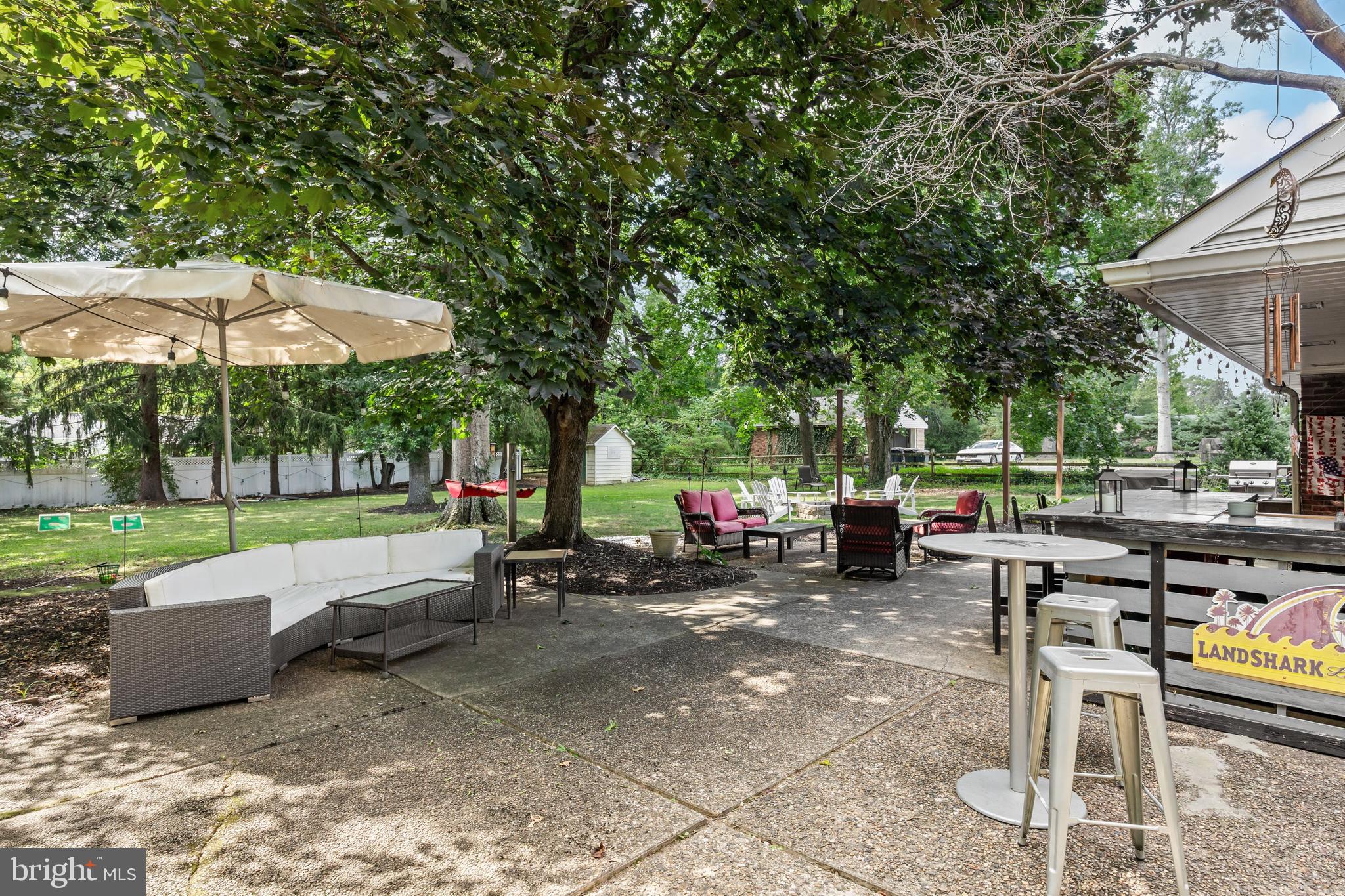 12 Greenvale Road Moorestown, NJ 08057 - Photo 33 of 49 a view of a patio with a table and chairs under an umbrella