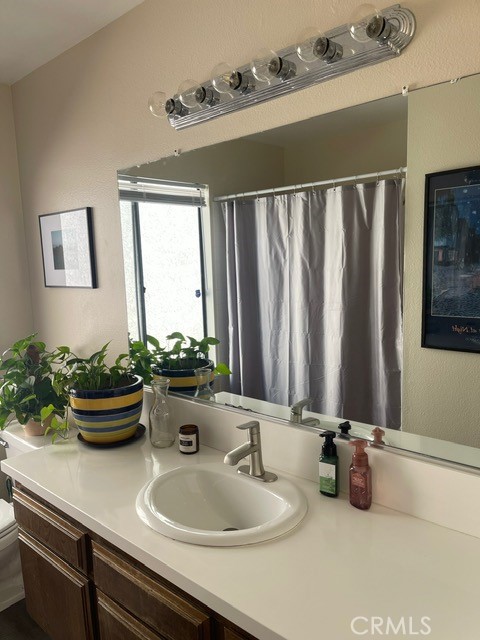 6435 Melray Street Moorpark, CA 93021 - Photo 16 of 41 a bathroom with a sink a mirror and potted plant