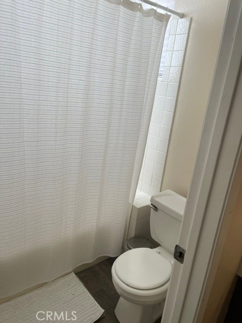 6435 Melray Street Moorpark, CA 93021 - Photo 19 of 41 a white toilet sitting next to a shower curtain
