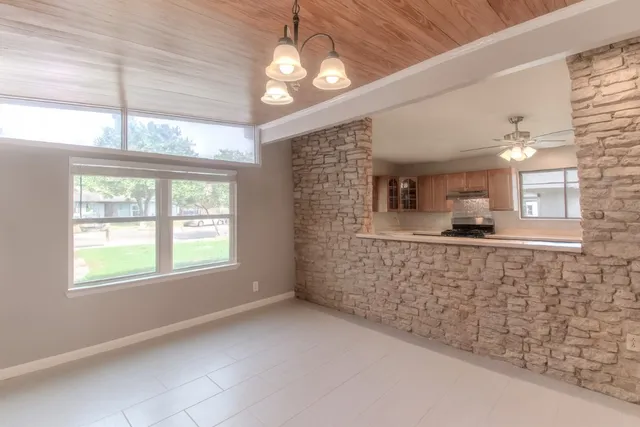 a kitchen with a center island appliances and cabinets