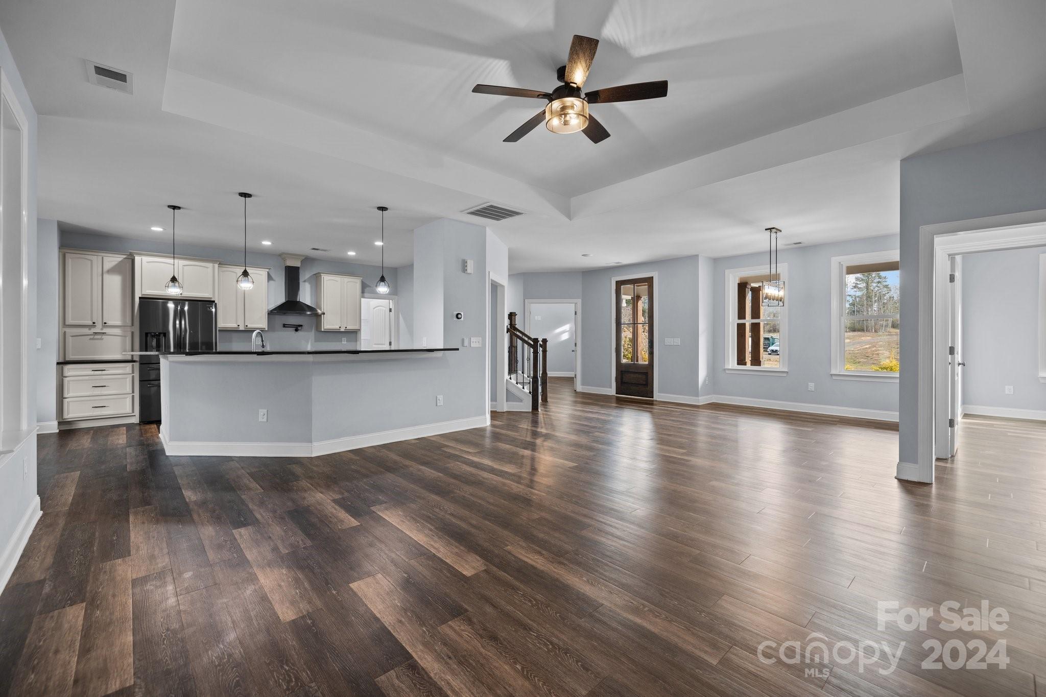 3067 Reservation Road Rock Hill, SC 29730 - Photo 13 of 45 a view of a kitchen with a kitchen island wooden floor appliances and a chandelier