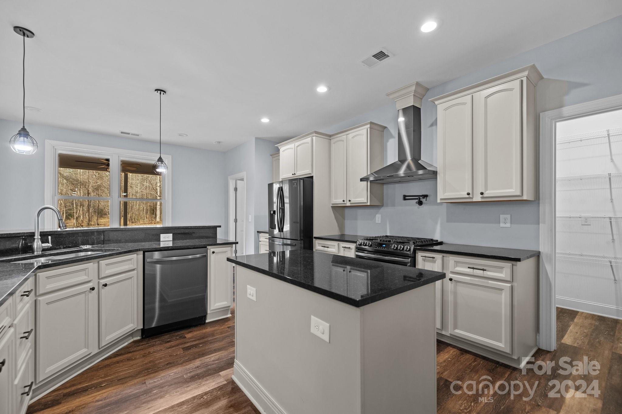 3067 Reservation Road Rock Hill, SC 29730 - Photo 17 of 45 a kitchen with stainless steel appliances granite countertop a stove a sink and a refrigerator