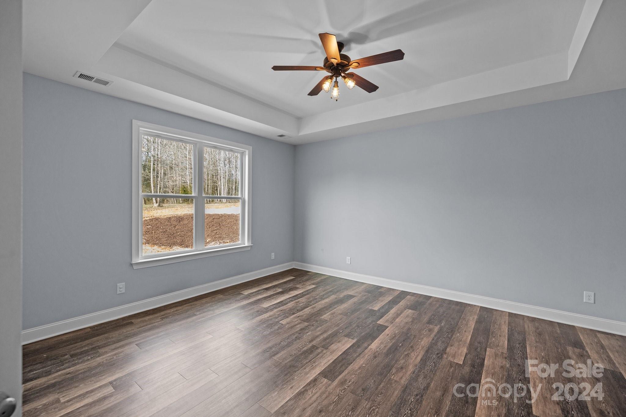 3067 Reservation Road Rock Hill, SC 29730 - Photo 25 of 45 an empty room with wooden floor fan and windows