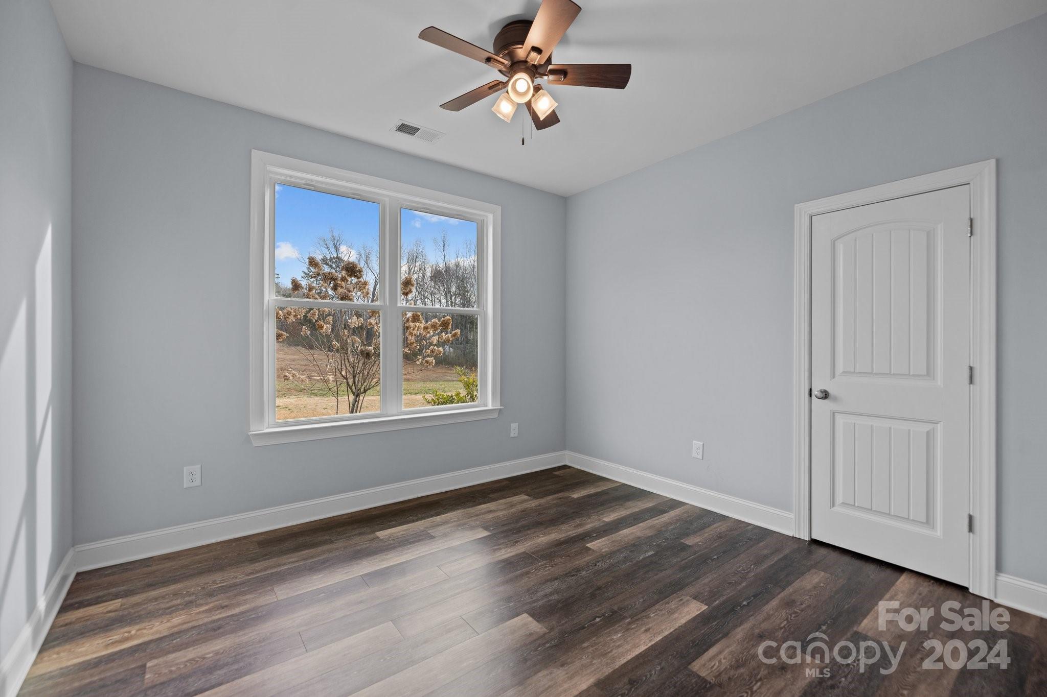 3067 Reservation Road Rock Hill, SC 29730 - Photo 29 of 45 a view of a livingroom with a window a ceiling fan and wooden floor