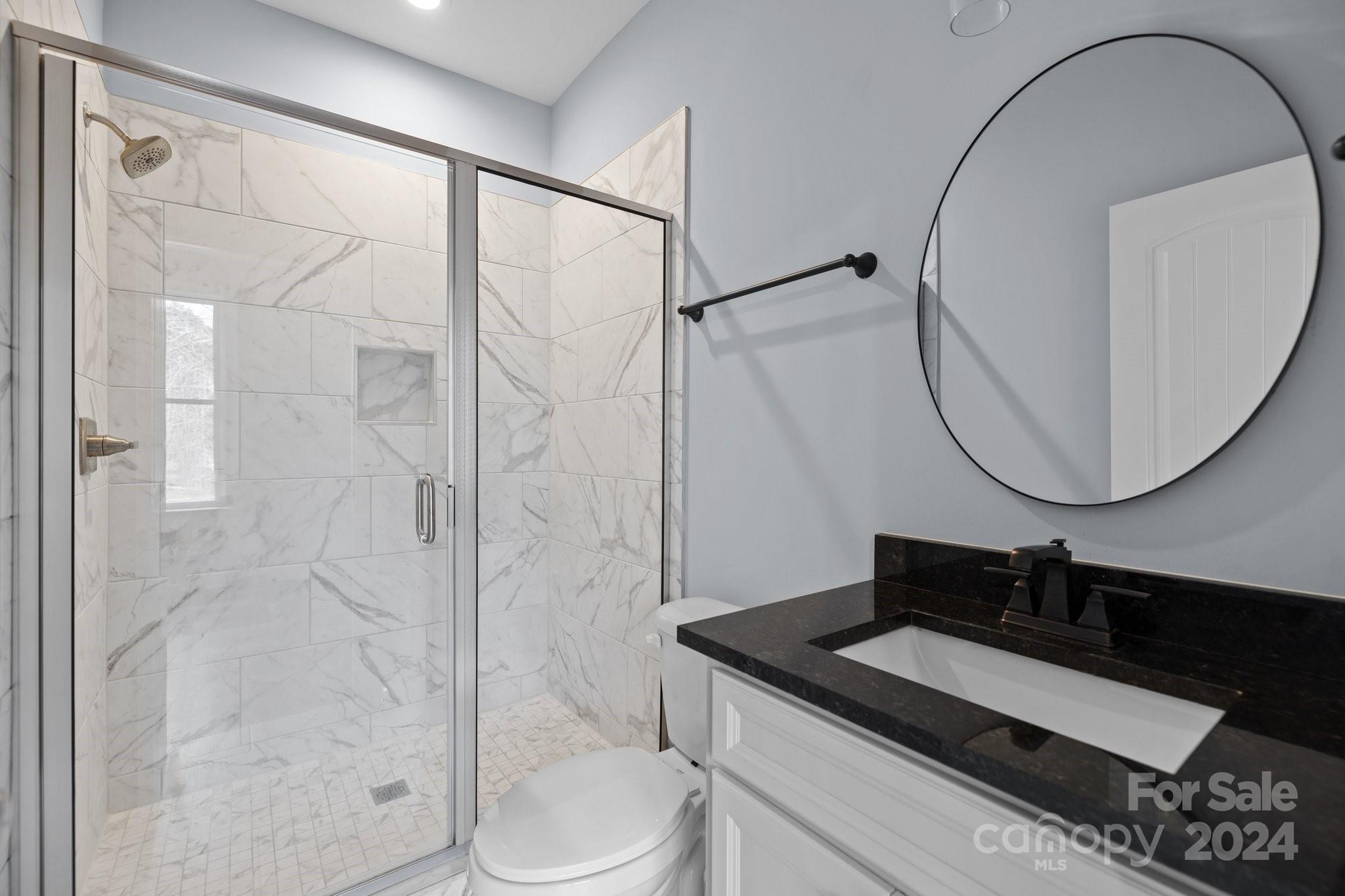 3067 Reservation Road Rock Hill, SC 29730 - Photo 38 of 45 a bathroom with a granite countertop sink a toilet and shower