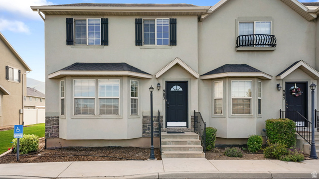 983 South 1850th Street West Springville, UT 84663 - Photo 1 of 30 Stucco exterior residence featuring bay windows, dark shutters, and a decorative Juliet balcony