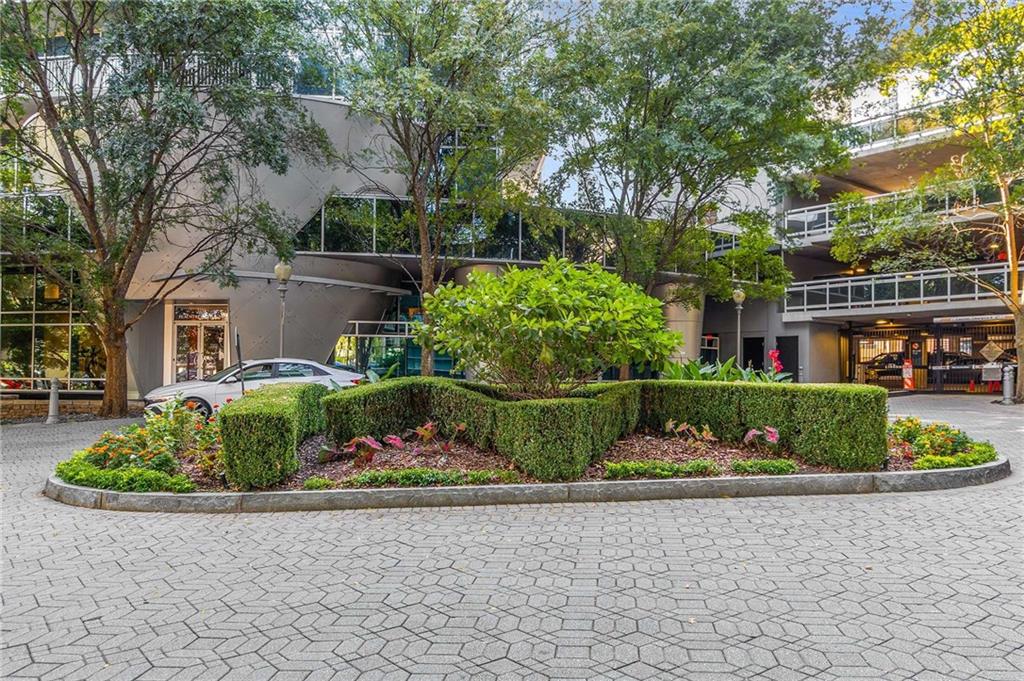 3338 Peachtree Road Northeast, Unit 407 Atlanta, GA 30326 - Photo 20 of 39 a front view of a house with a yard and outdoor seating