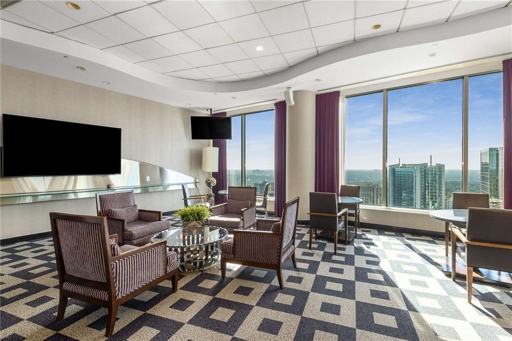 3338 Peachtree Road Northeast, Unit 407 Atlanta, GA 30326 - Photo 30 of 39 a living room with furniture and a flat screen tv