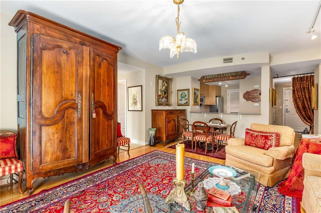 3338 Peachtree Road Northeast, Unit 407 Atlanta, GA 30326 - Photo 9 of 39 a living room with furniture and a chandelier