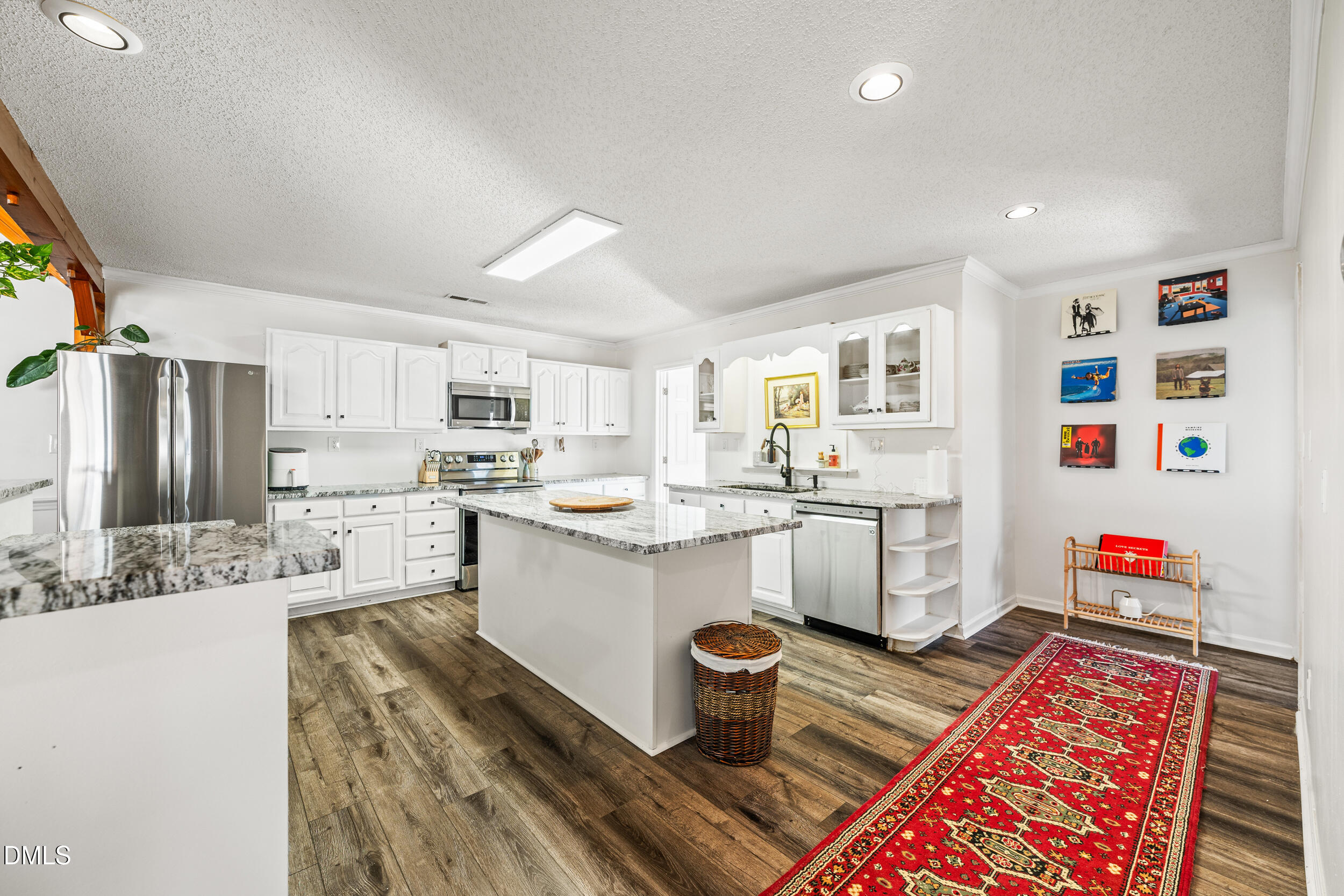2618 Brame Road Greensboro, NC 27405 - Photo 14 of 64 a kitchen that has a lot of white cabinets and stainless steel appliances