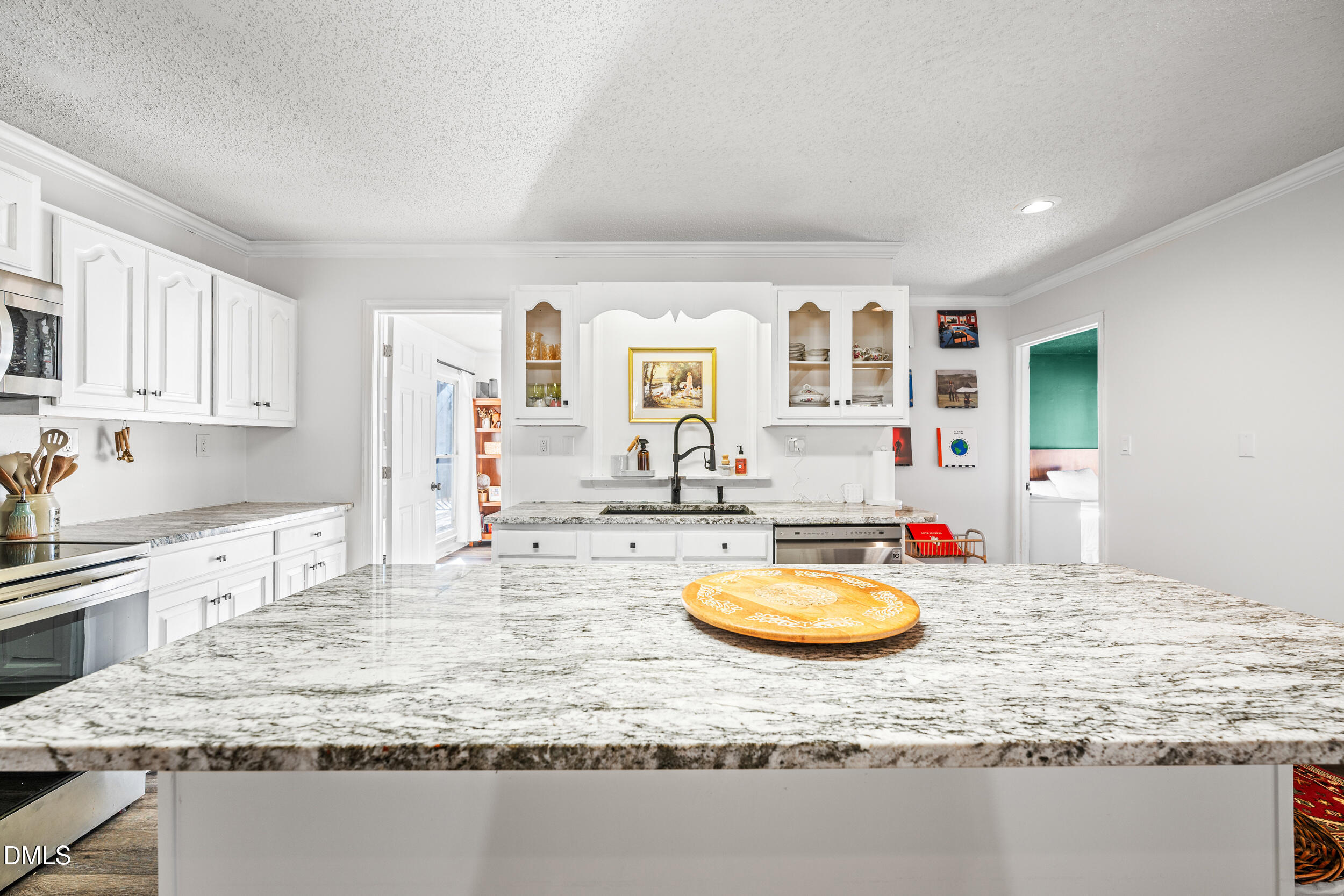 2618 Brame Road Greensboro, NC 27405 - Photo 16 of 64 a kitchen with kitchen island granite countertop a stove and a sink