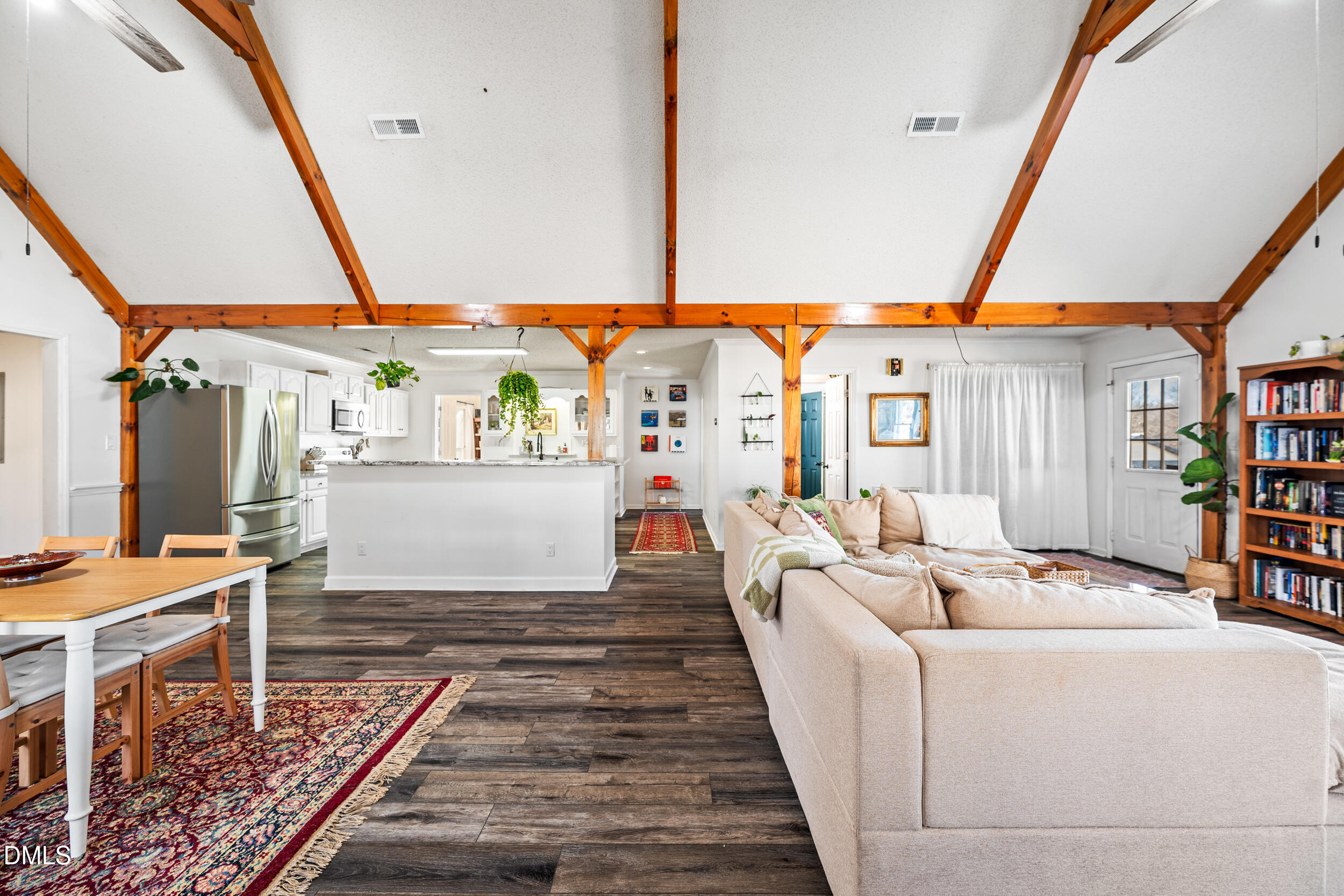 2618 Brame Road Greensboro, NC 27405 - Photo 7 of 64 a living room with furniture a rug and a floor to ceiling window