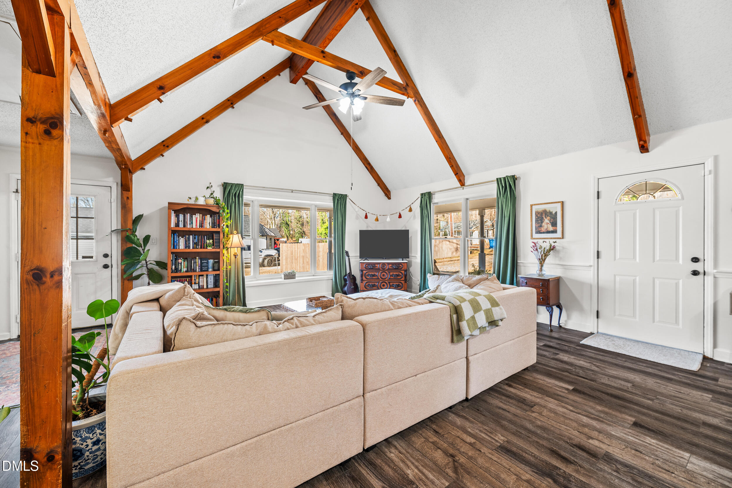2618 Brame Road Greensboro, NC 27405 - Photo 9 of 64 a living room with furniture a flat screen tv and a floor to ceiling window