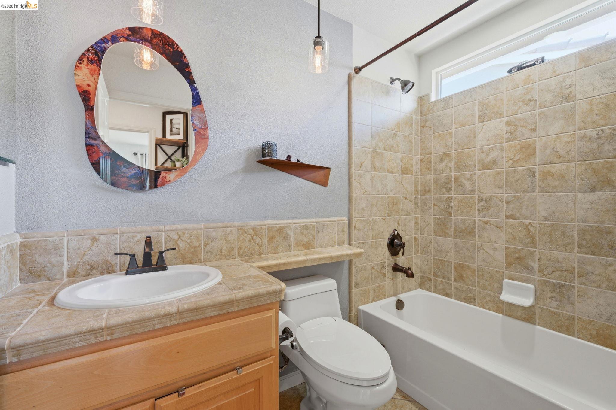 1024 Diamante Rio Vista, CA 94571 - Photo 19 of 27 Bathroom featuring a vanity with tile countertop, undermount sink, and wood-finish cabinetry