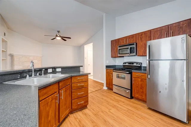 a kitchen with stainless steel appliances granite countertop a sink stove and refrigerator