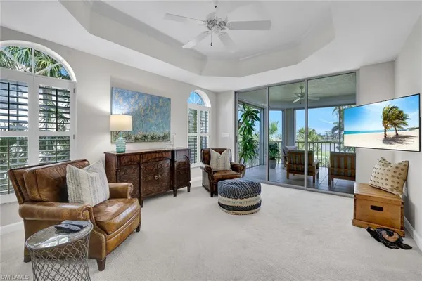 a living room with furniture and a floor to ceiling window