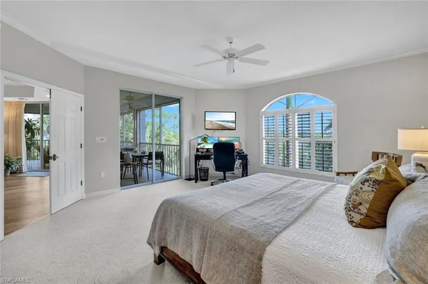 a bedroom with a large bed and a large window