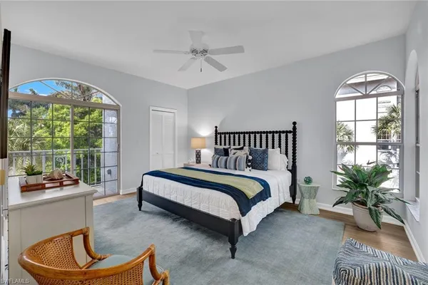 a spacious bedroom with a bed and a large window