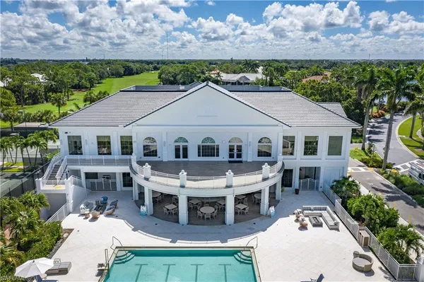 a aerial view of a house with a yard table and chairs