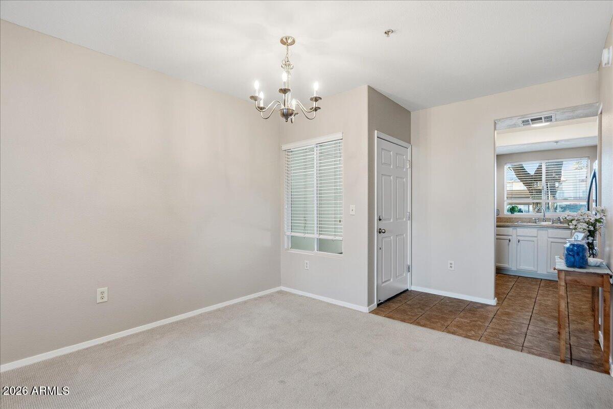 1825 West Ray Road, Unit 1106 Chandler, AZ 85224 - Photo 10 of 62 a view of a livingroom with a chandelier fan and windows