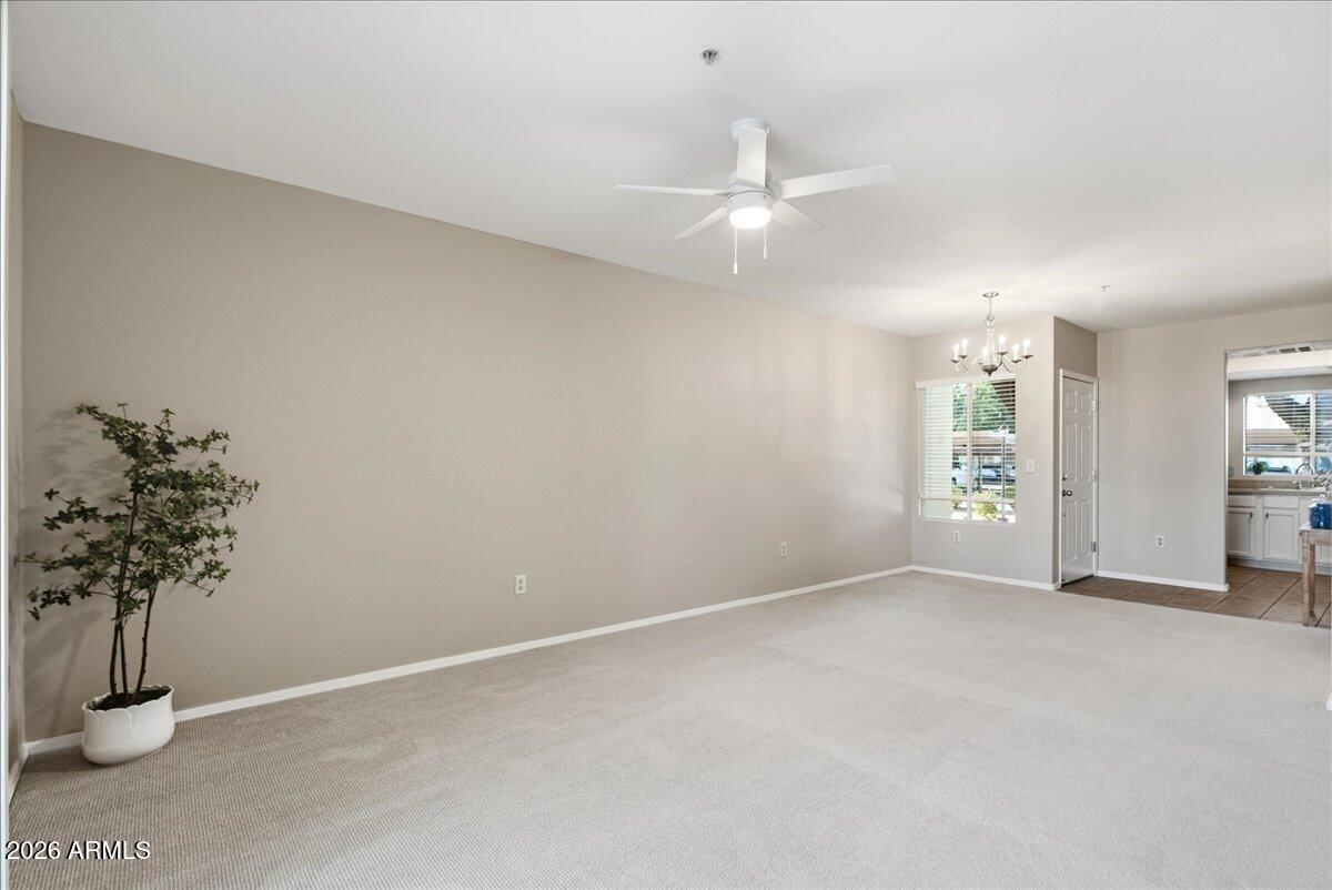 1825 West Ray Road, Unit 1106 Chandler, AZ 85224 - Photo 12 of 62 an empty room with windows and flower pot