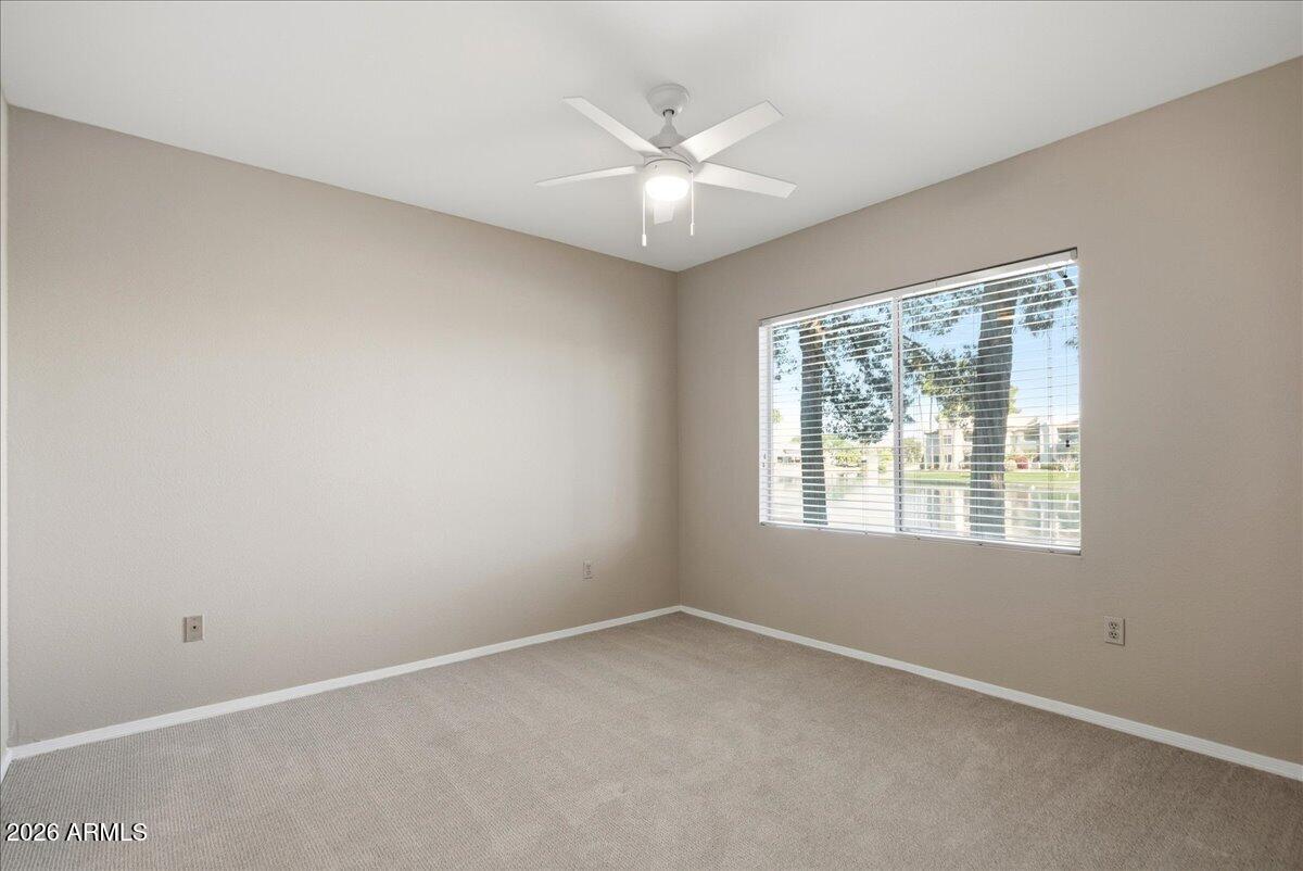 1825 West Ray Road, Unit 1106 Chandler, AZ 85224 - Photo 15 of 62 an empty room with a window and a ceiling fan