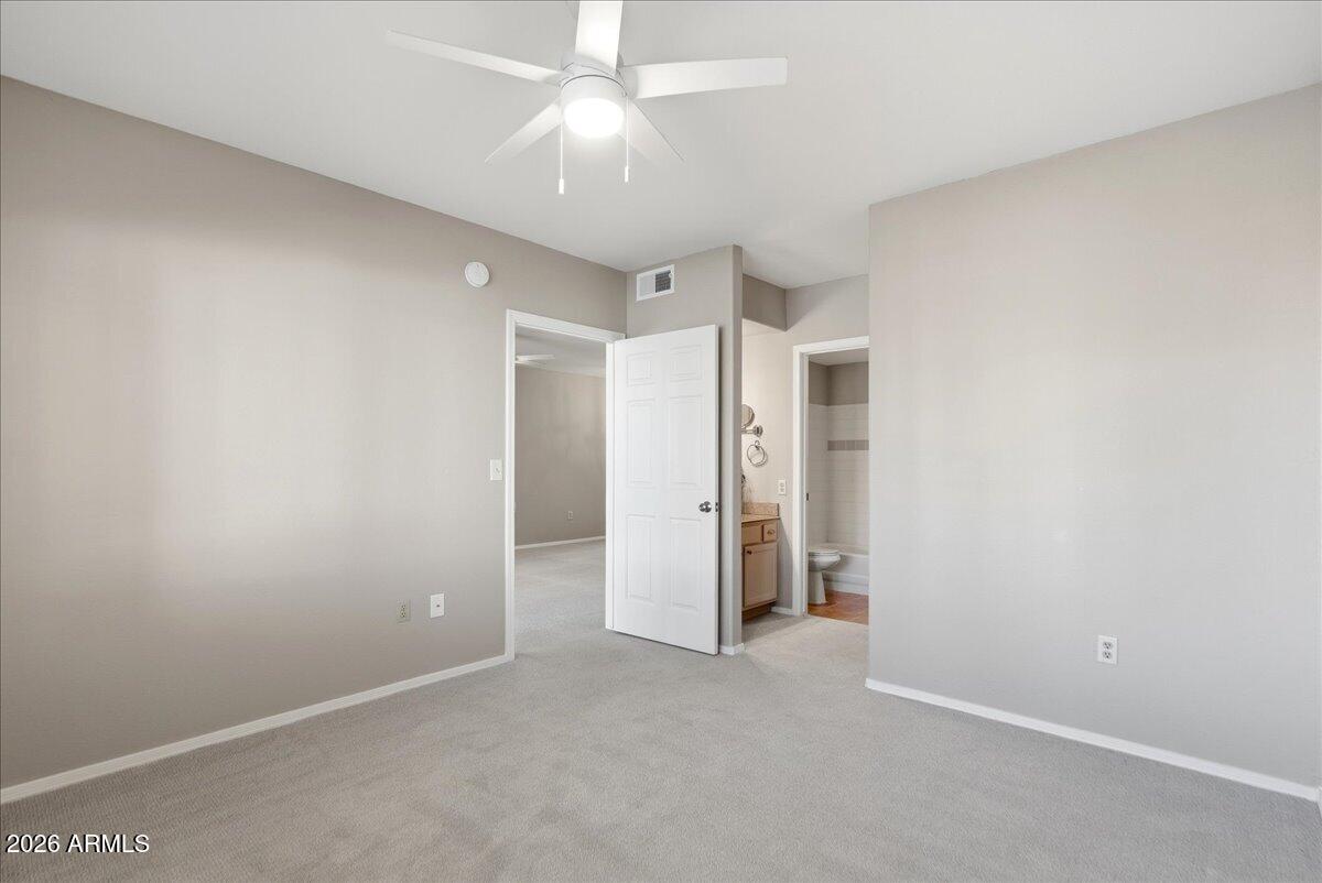 1825 West Ray Road, Unit 1106 Chandler, AZ 85224 - Photo 16 of 62 an empty room with a ceiling fan and entryway