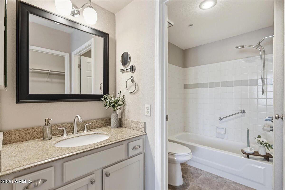 1825 West Ray Road, Unit 1106 Chandler, AZ 85224 - Photo 17 of 62 a bathroom with a granite countertop sink toilet and shower
