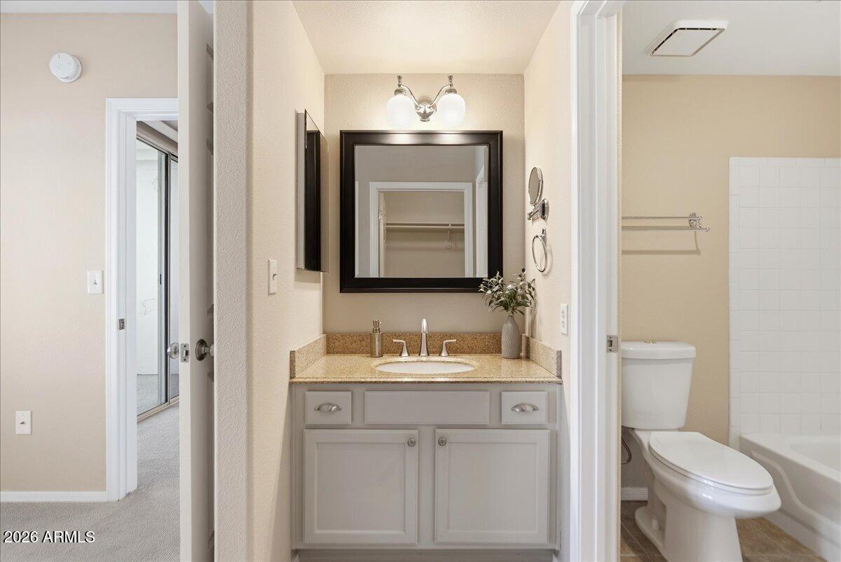 1825 West Ray Road, Unit 1106 Chandler, AZ 85224 - Photo 18 of 62 a bathroom with a toilet sink and mirror