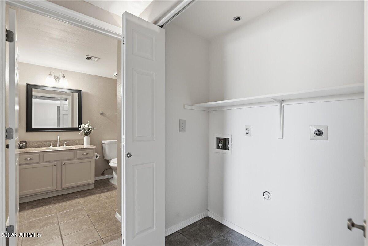 1825 West Ray Road, Unit 1106 Chandler, AZ 85224 - Photo 24 of 62 a bathroom with a granite countertop sink a mirror and a bathtub