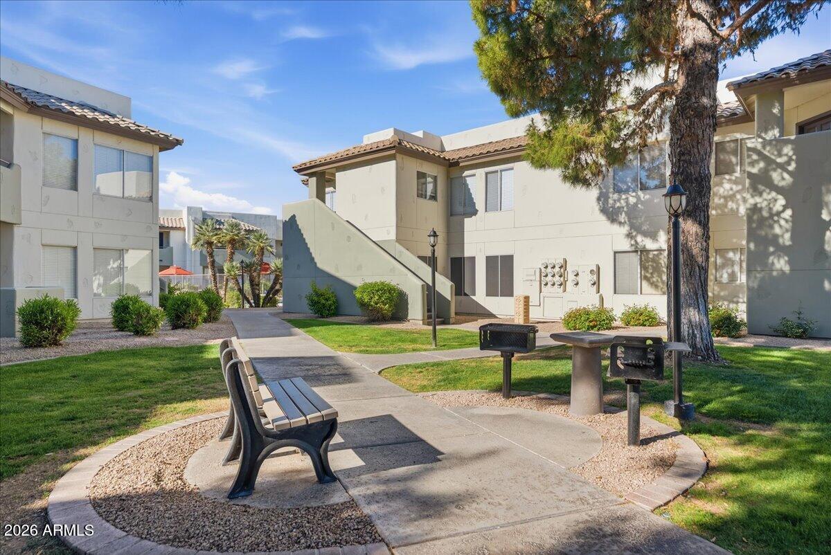1825 West Ray Road, Unit 1106 Chandler, AZ 85224 - Photo 35 of 62 a view of a house with backyard sitting area and garden