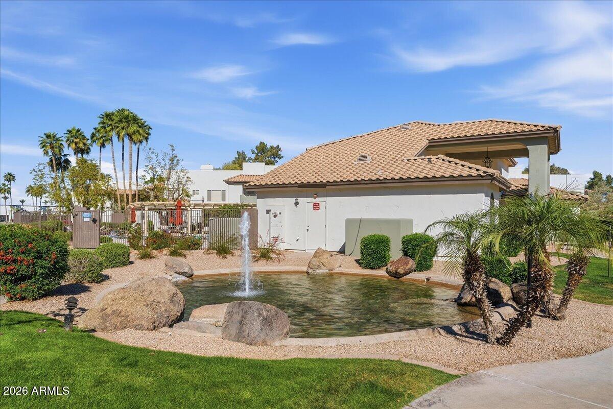 1825 West Ray Road, Unit 1106 Chandler, AZ 85224 - Photo 39 of 62 a front view of a house with garden