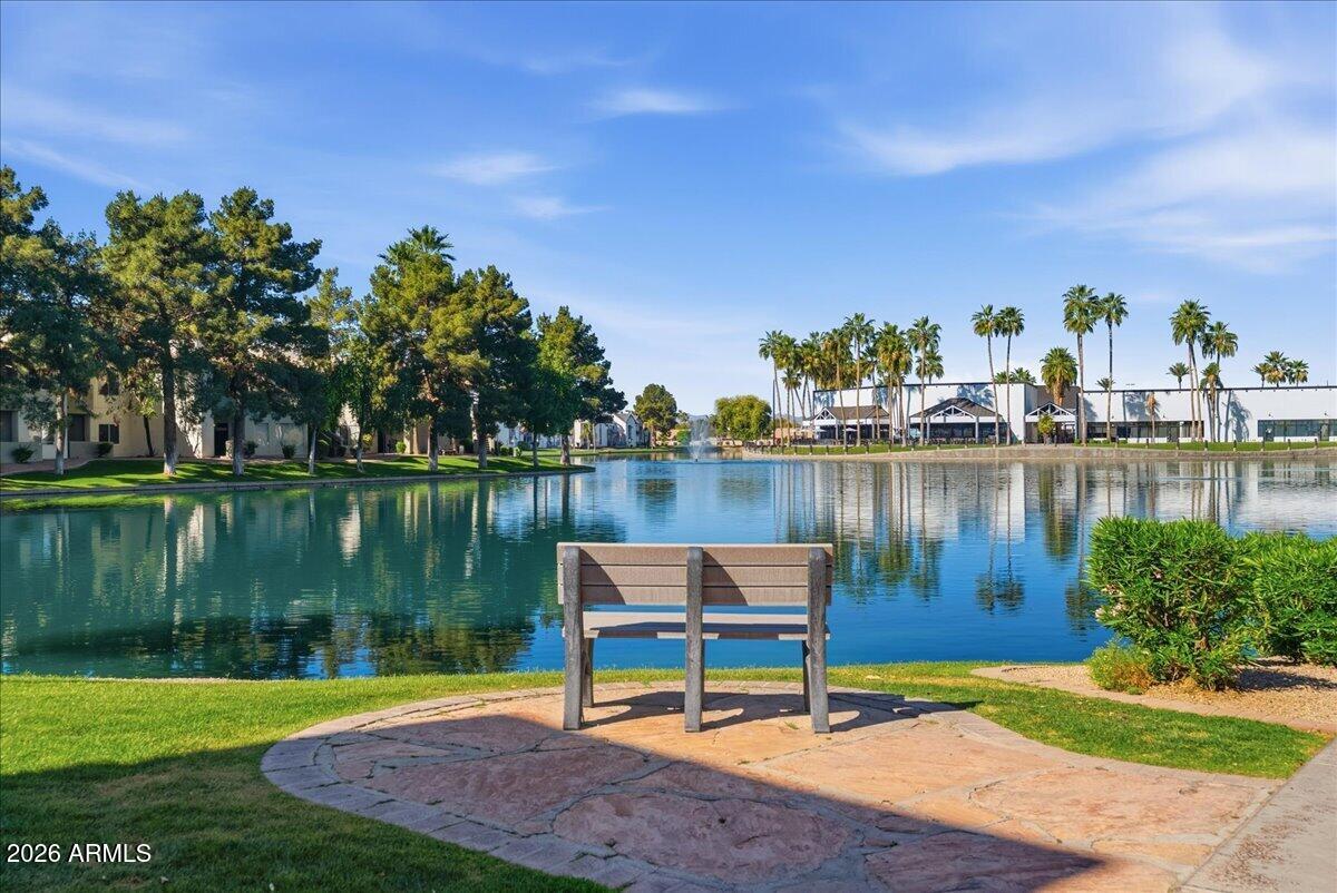 1825 West Ray Road, Unit 1106 Chandler, AZ 85224 - Photo 40 of 62 a lake view with a bench and lake view