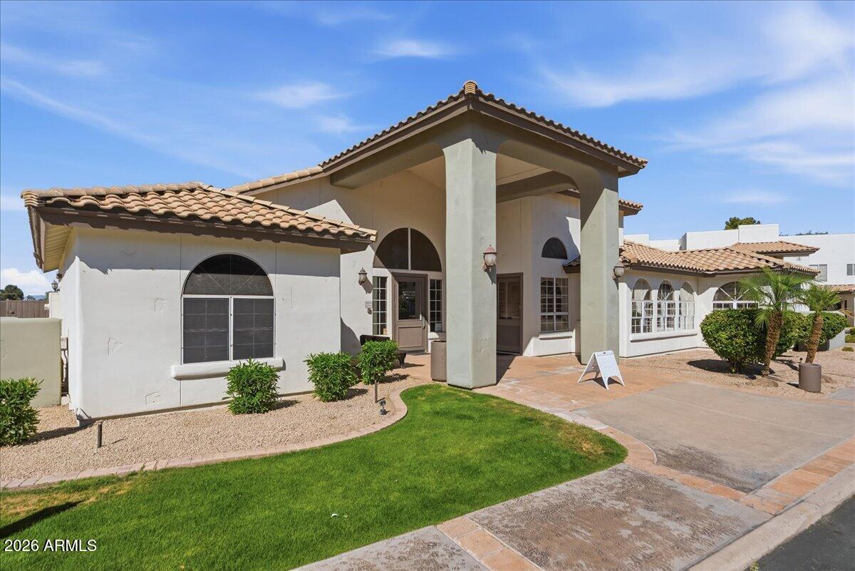 1825 West Ray Road, Unit 1106 Chandler, AZ 85224 - Photo 41 of 62 a front view of a house with a yard